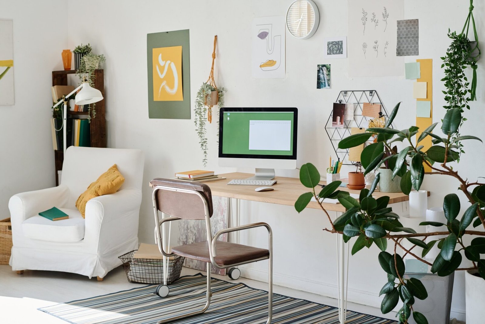 Part of living room with workplace of freelance webdesigner by wall